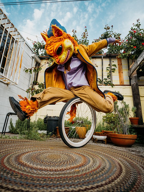 Noname 0146 - JOSHUA ROSE - colorful tiger costume on single tricycle wheel