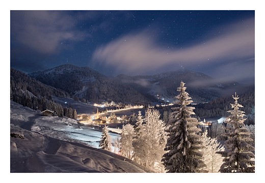 KPM2-whispy-clouds-snowy-mountain-village
