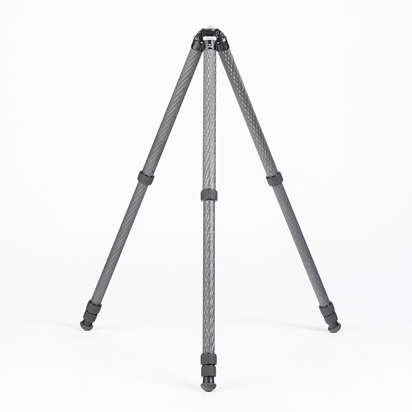 a black tripod stands with legs partially extended on a white background