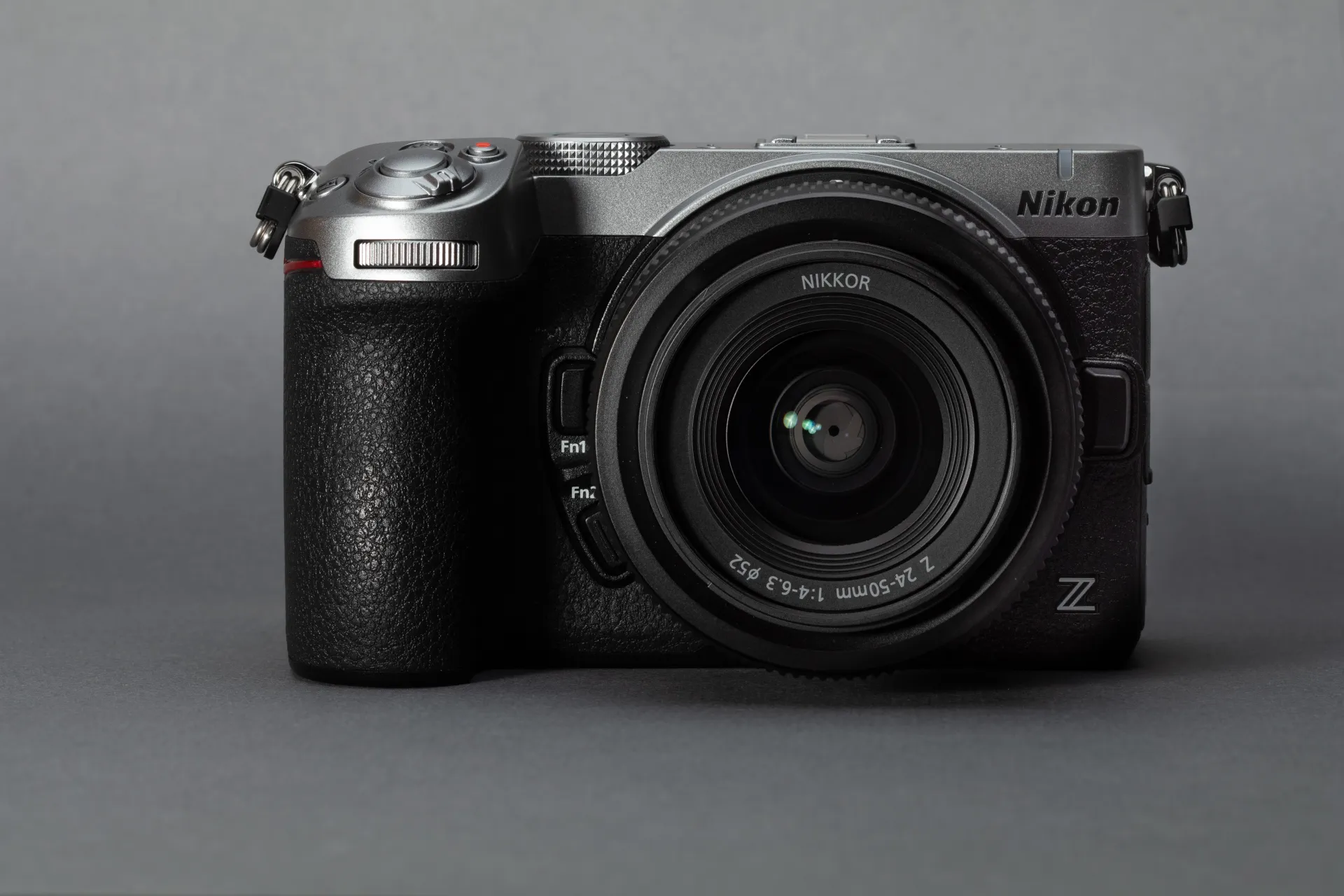 A straight-on view of a silver Nikon Z5IIC with a 24-50mm F4-6.3 lens attached.