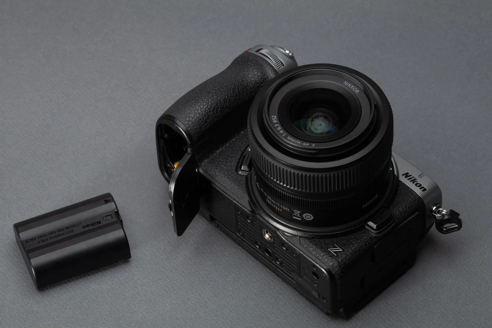The Nikon Z5IIC seen from above, with its battery laying beside it.
