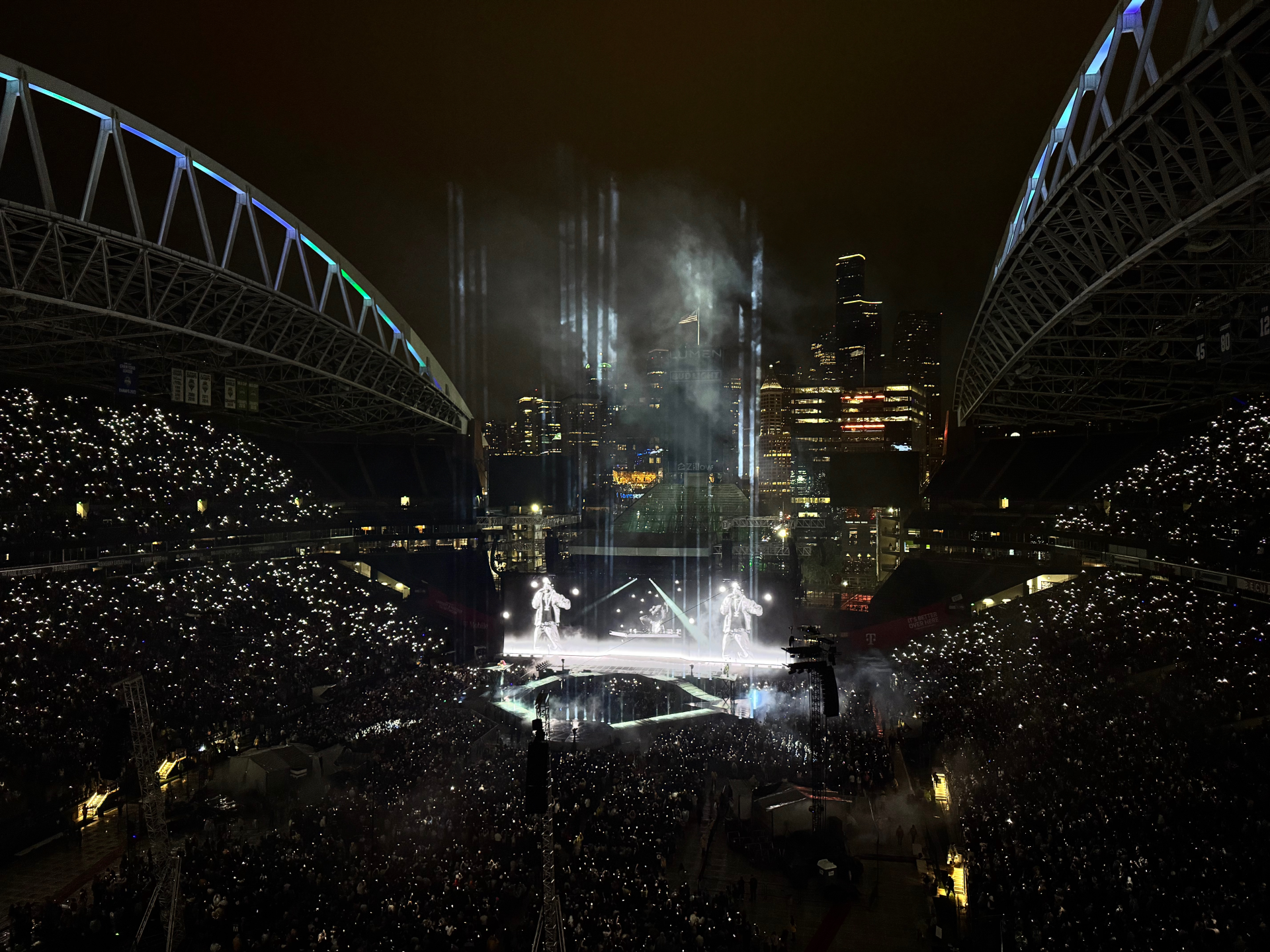 A concert being performed at a packed stadium.